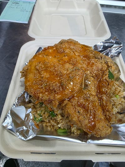Cook'd — glazed half-chicken atop fried rice from Chef Sam Ransom Jr.