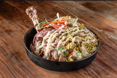 JerkCity Grille — jerk chicken plate over seasoned rice with peppers, parsnip, and white sauce drizzle