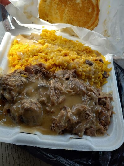JerkCity Grille — slow-simmered oxtails over yellow rice with brown gravy and cornbread
