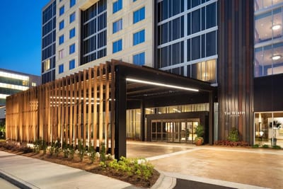 The Westin Jackson entrance at dusk — signature wood-slat pergola and illuminated Westin signage